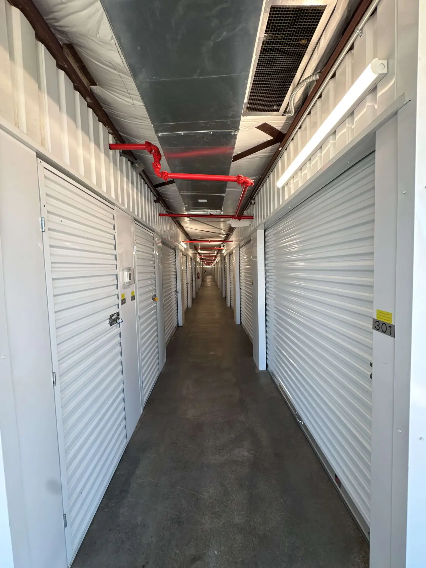 Climate-controlled unit hallway with bright overhead lighting