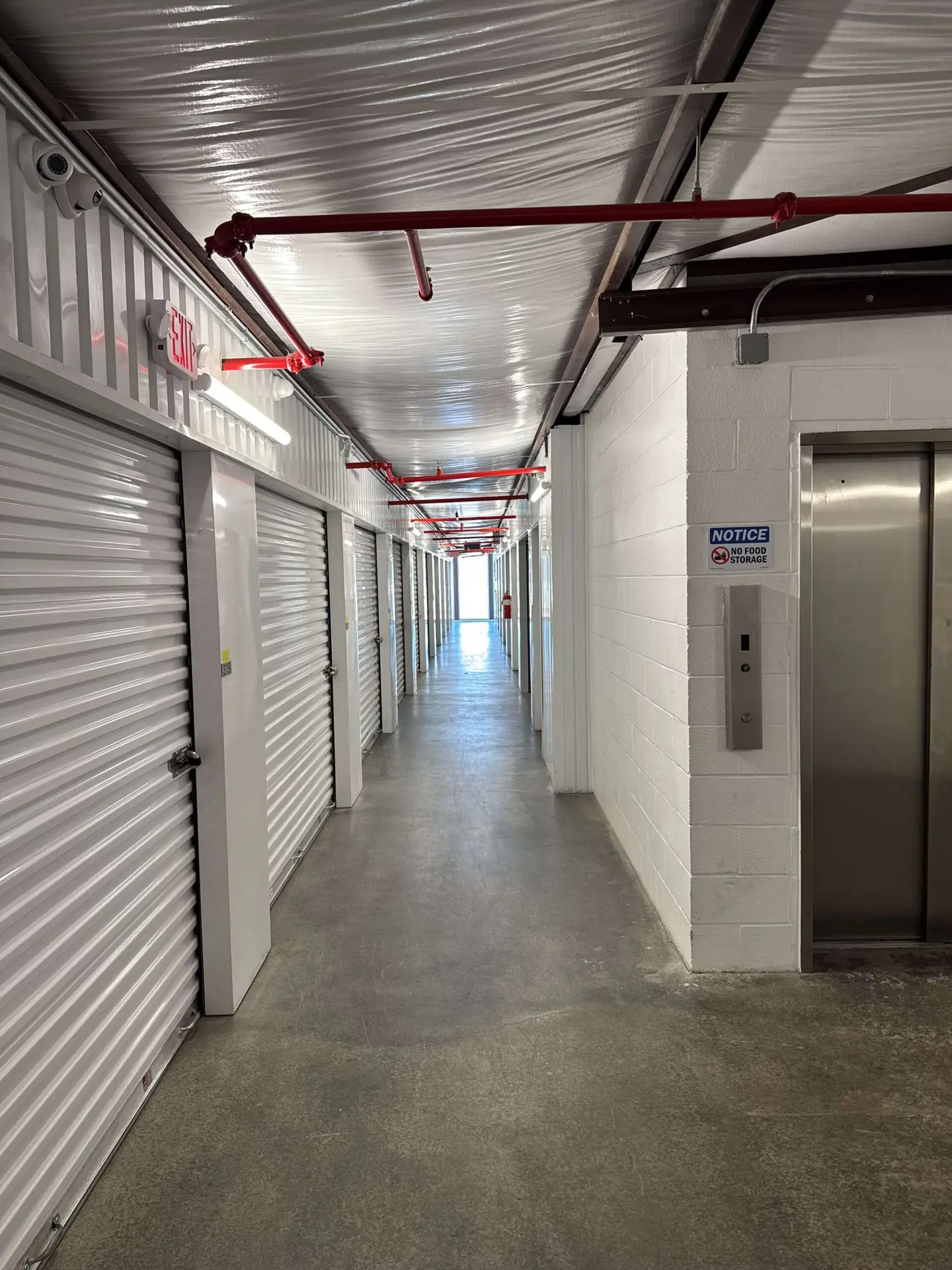 Clean storage unit interior with concrete floor at Storage Solutions Plus
