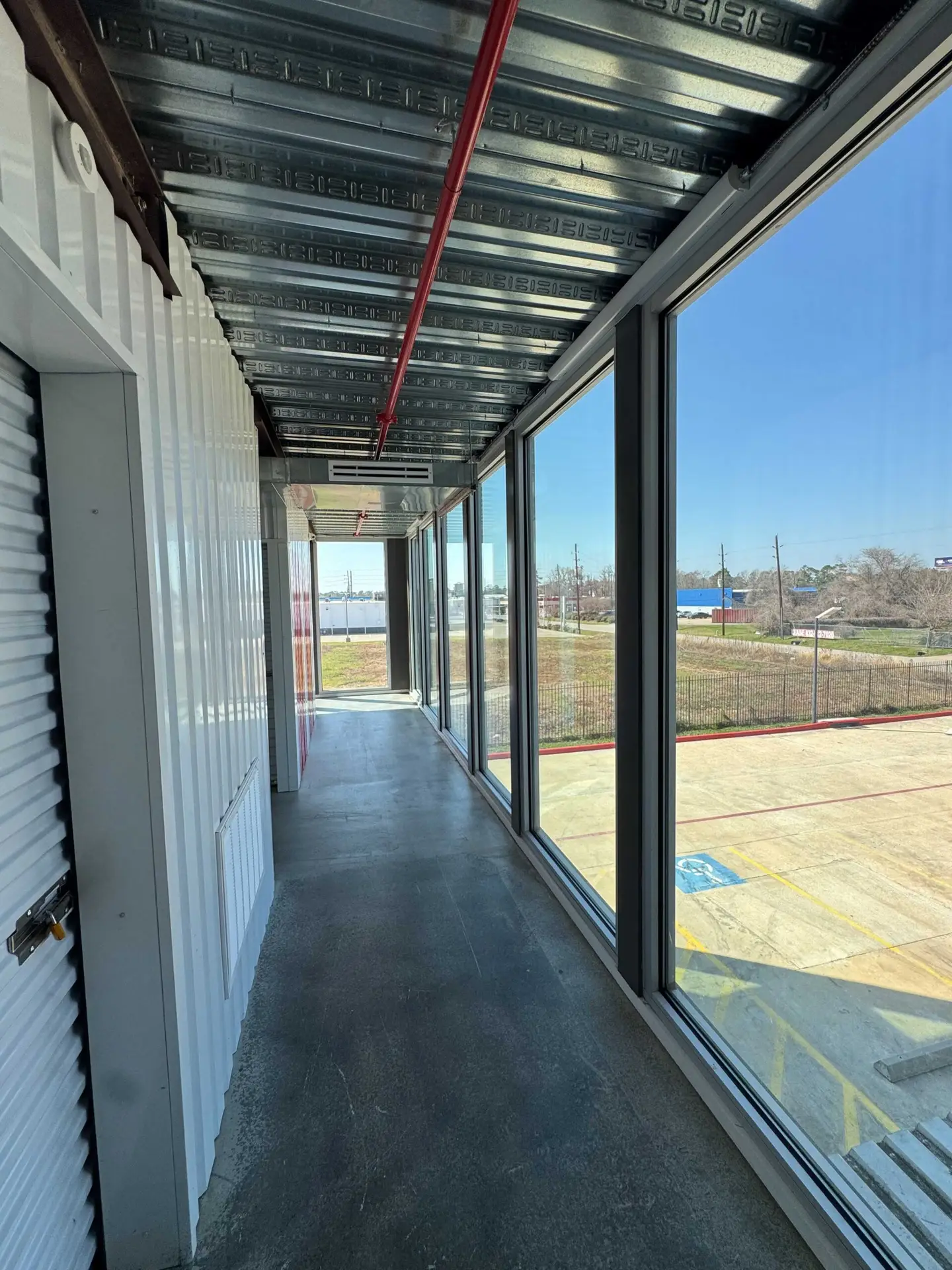 Clean, well-lit hallway of indoor climate-controlled storage units at Storage Solutions Plus.